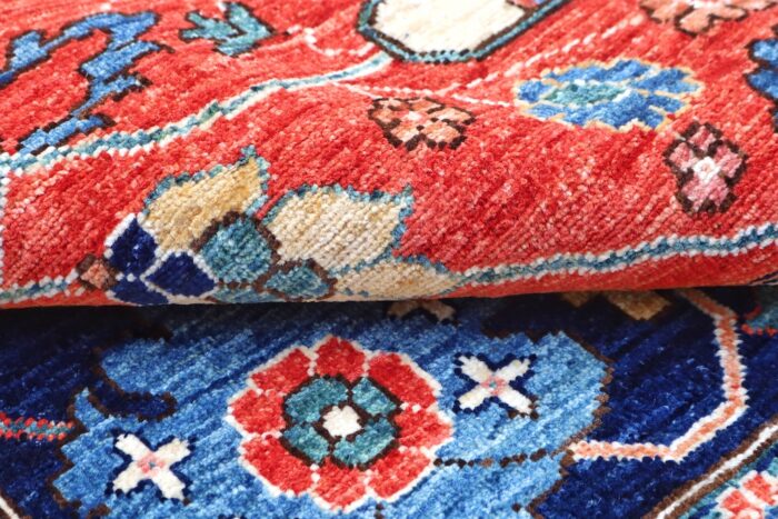 Hand-knotted Persian-style area rug with a vibrant red field and navy blue border, featuring intricate floral motifs – 8'1" x 9'8