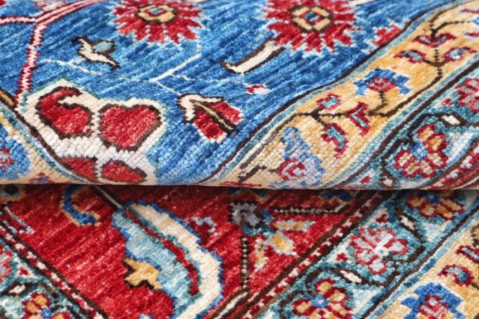 Vintage-inspired wool rug with hand-knotted craftsmanship, showcasing symmetrical motifs and rich colors