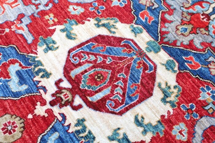 Classic red and blue Persian design rug with an ornate border, adding warmth and sophistication to any home.