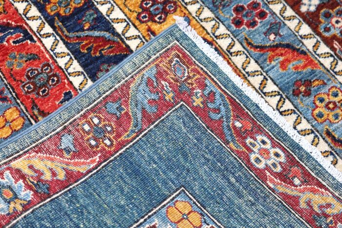 Authentic Persian Bijar tribal rug with intricate hand-knotted wool design in red, blue, and gold tones