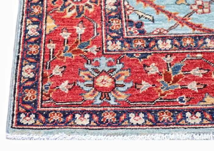 5x7 handmade wool rug with Persian-inspired floral design in sky blue, red, and navy – washable and durable