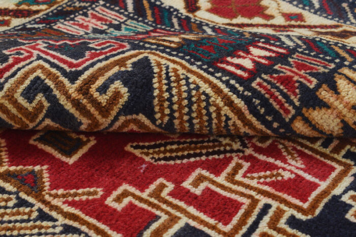 Handwoven tribal rug with intricate geometric patterns in red, navy, and beige. Washable, durable, and perfect for any space