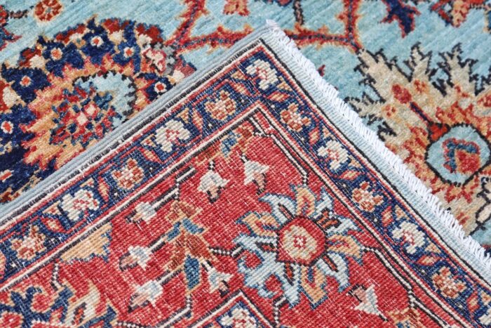 Luxury 5x7 area rug with a powder blue background and deep red border, ideal for classic interiors