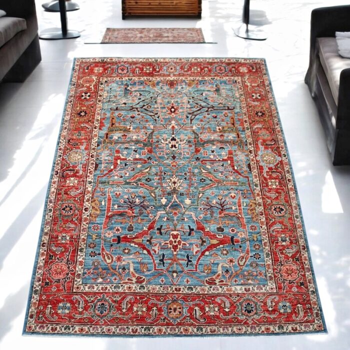 Traditional 5x7 wool Ziegler rug with bold geometric motifs and a balanced color palette of blue, ivory, and gold