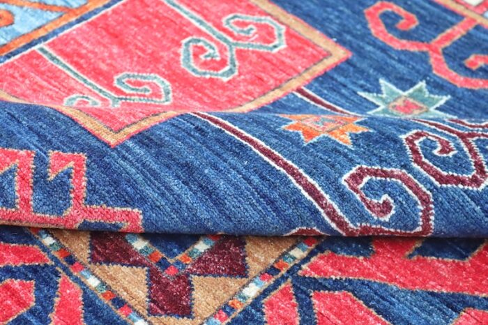 Traditional Kurdish design rug with red, orange, and sky blue geometric motifs.