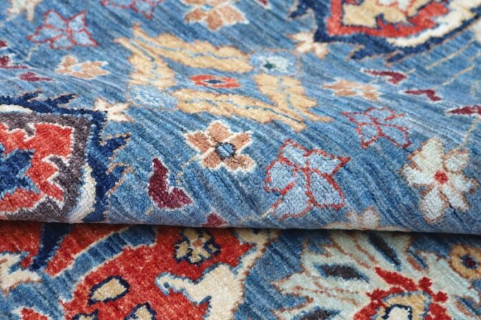 Handwoven 8x10 Heriz rug with blue background and intricate Persian-style motifs