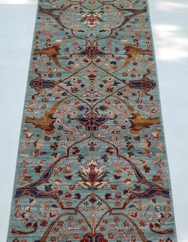 Handwoven 2.5x9.9 sky blue and rust Ziegler runner rug with intricate floral patterns.