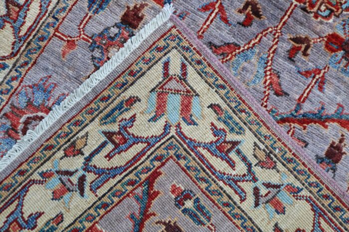 Handwoven 2.6x13.9 gray and red Tabriz runner rug with intricate floral medallions.