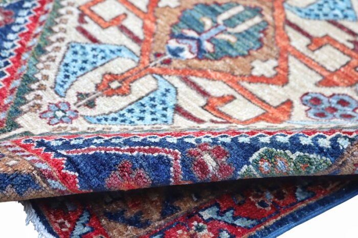 Long Persian-style Heriz rug with red, navy blue, and ivory tones, great for floor or wall décor