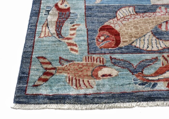 Handmade 4'11 x 6'10 wool rug with vibrant fish design in blue, red, and beige, perfect for living rooms or coastal decor."