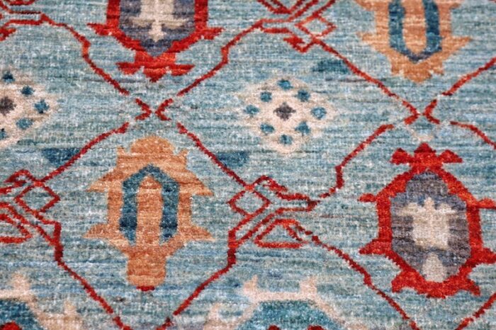 Traditional 4x6 Kazak wool rug featuring bold medallions in soft gray, rust red, and deep blue tones.