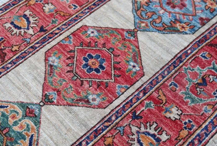 Traditional Heriz-style rug with vintage geometric patterns and warm tones