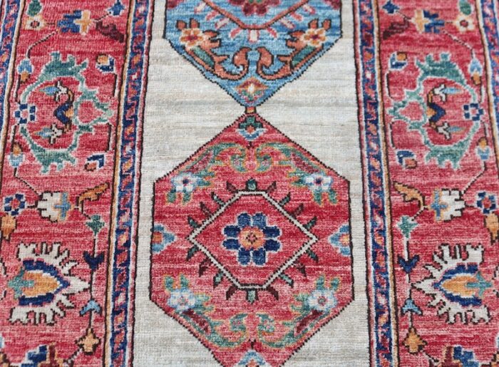 Traditional Heriz-style rug with vintage geometric patterns and warm tones