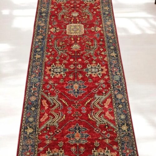 Handwoven 3.2x11.10 red and navy Heriz runner rug with bold geometric medallions.