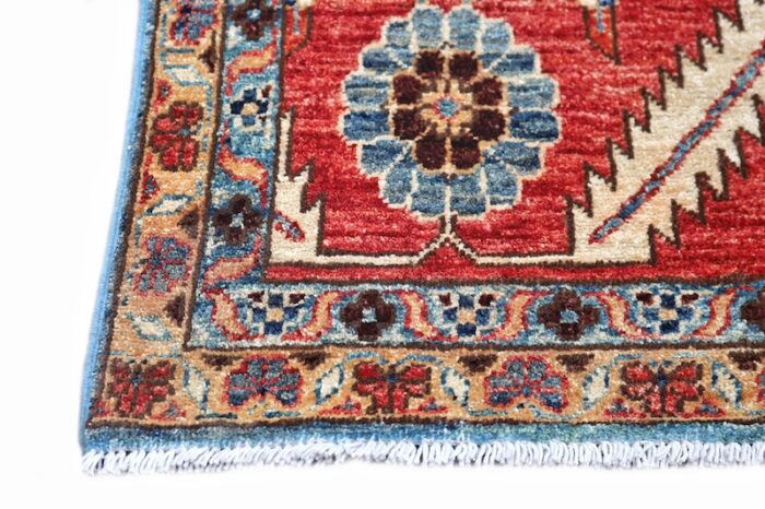 Traditional 8x10 Persian-style Heriz rug with a denim blue background, red borders, and ivory accents