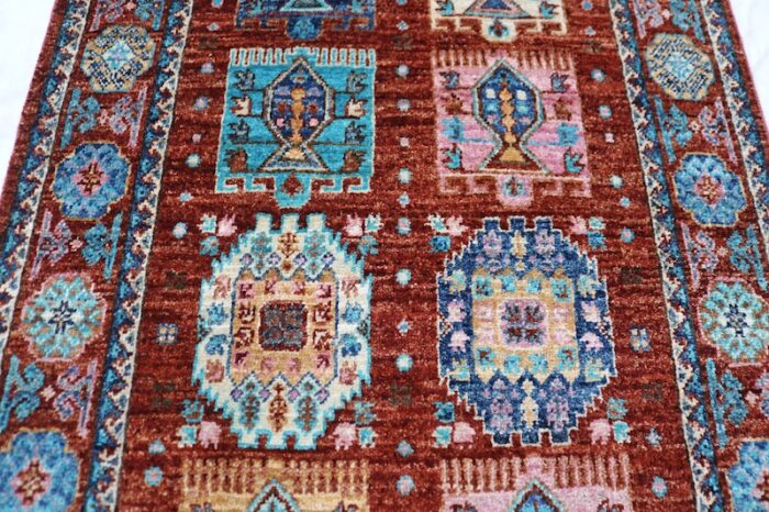 Vintage-inspired 2.4x10 Kazak wool runner rug with a bold, traditional design.