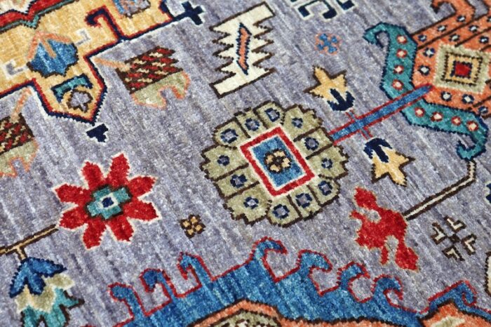 Traditional 4x6 Kazak wool rug featuring bold medallions in soft gray, rust red, and deep blue tones