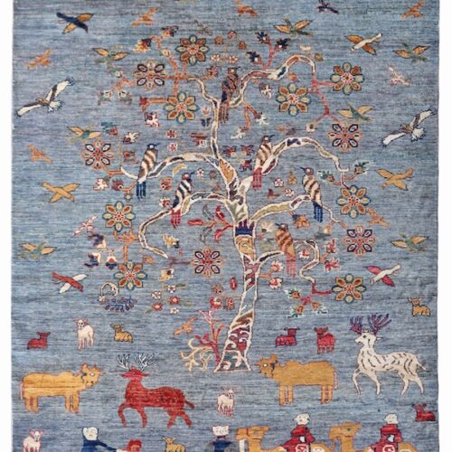 Beautifully woven Tree of Life rug with birds in flight, symbolizing harmony and freedom.