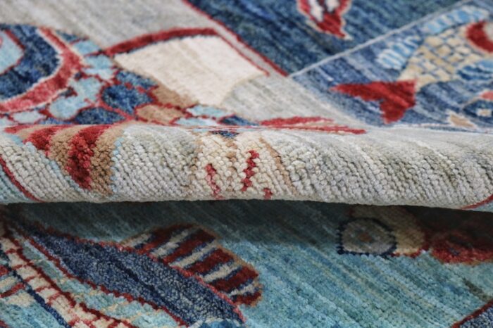 Persian-inspired fish motif area rug in coastal blue, red, and ivory colors, handmade with durable wool, 4'11 x 6'10.