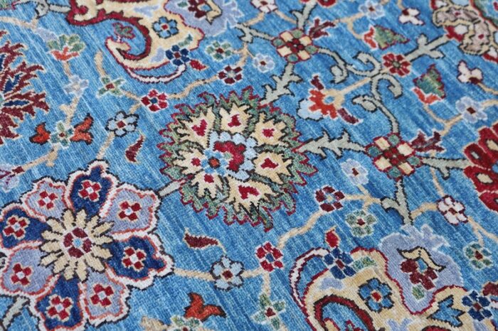 Handwoven 9x11.6 Persian Serapi rug with sky blue background and intricate floral motifs.