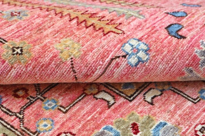 6x9 handmade Persian Heriz wool rug with intricate geometric and floral patterns in coral pink, blue, and ivory