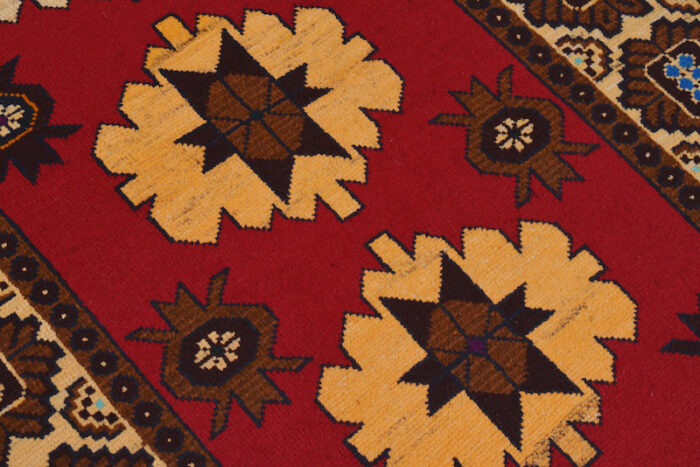 Geometric Afghan Baluch rug with rich red, beige, and black tones. Soft, durable, and stain-resistant for high-traffic areas."