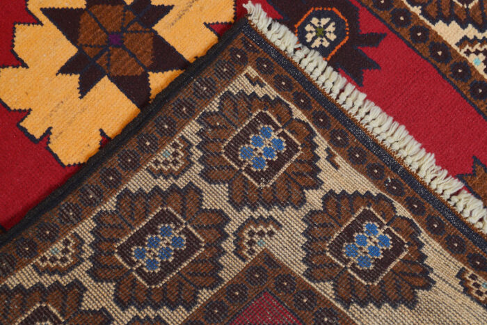 Beautiful Afghan tribal rug with deep red, gold, and navy colors. Handwoven, easy to clean, and a timeless addition to any home."