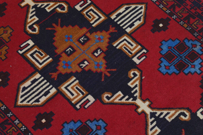 Geometric Afghan Baluch rug with rich red, navy, and ivory tones. Soft, durable, and stain-resistant for high-traffic areas."