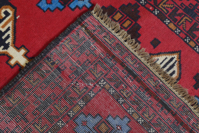 Beautiful Afghan tribal rug with deep red, blue, and beige accents. Handwoven, easy to clean, and a timeless addition to any home.