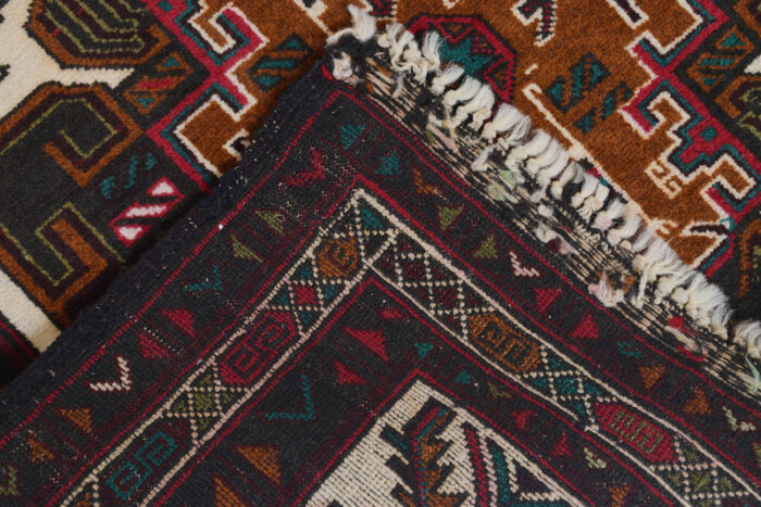 Beautiful Afghan tribal rug with deep red, navy, and beige accents. Handwoven, easy to clean, and a timeless addition to any home