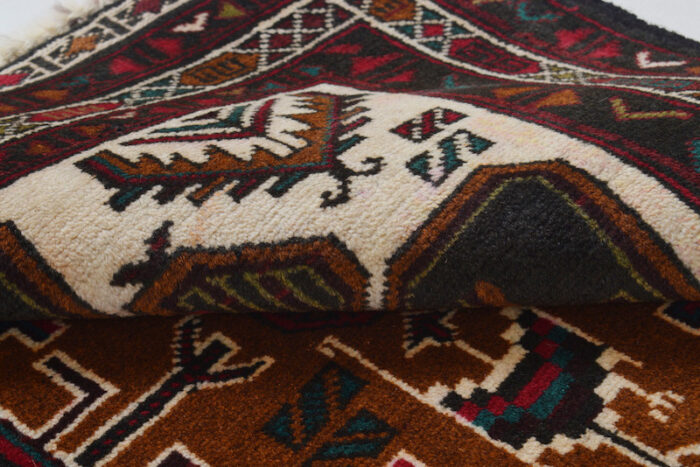 Washable 4.4x2.9 feet Afghan Baluch rug with striking geometric designs. A durable and elegant statement piece for any space.