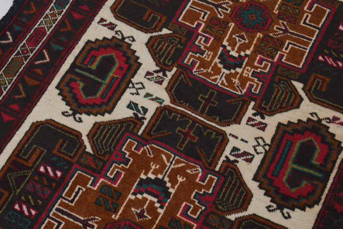 Handwoven Afghan Baluch rug with bold geometric patterns in rich brown, deep red, and ivory. Washable, durable, and perfect for any space."