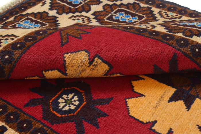 Handwoven Afghan Baluch rug with bold geometric floral patterns in deep red, beige, and dark navy. Washable, durable, and perfect for any space."