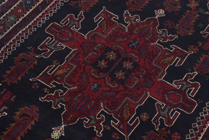 Authentic Afghan wool rug with bold geometric motifs in black, maroon, and ivory, available near me