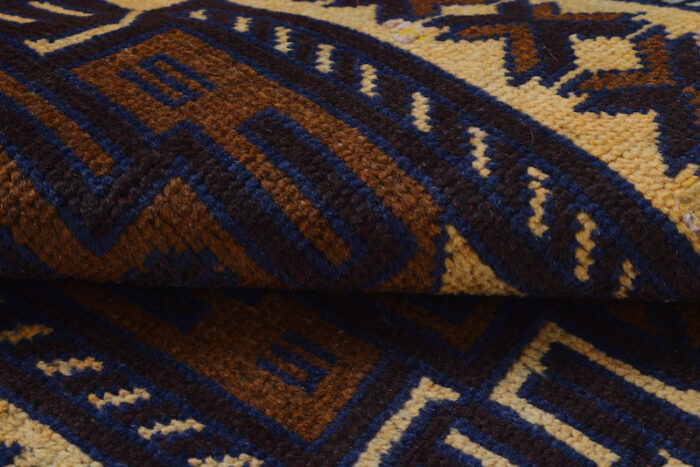 Handwoven Afghan Baluch rug 4'8 x 2'9 ft in warm beige and deep brown with intricate geometric medallions. Available in San Francisco, Berkeley, and San Rafael."