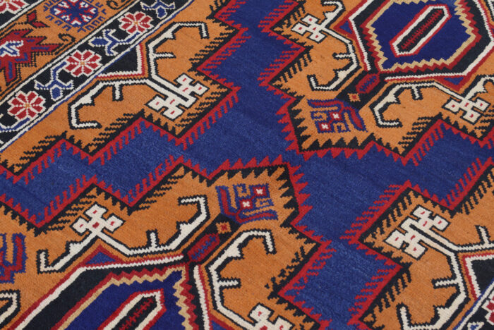 Handwoven Afghan rug 6'9 x 4'3 ft with traditional tribal motifs in deep red, blue, and orange-brown. Perfect for vintage and modern interiors