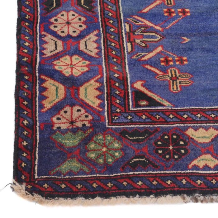 Authentic Afghan tribal rug featuring intricate hand-knotted geometric motifs in navy blue, red, ivory, and brown. Perfect for modern and traditional interiors.