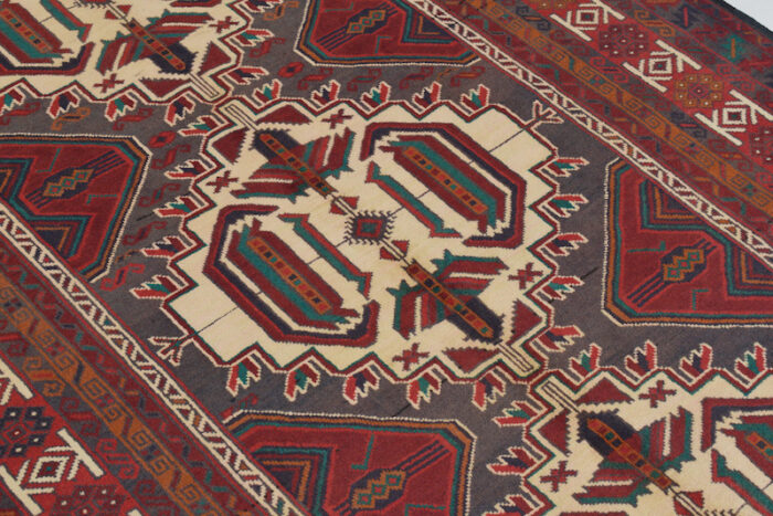 Handwoven Afghan Baluchi rug 6'8 x 4'1 ft with ivory base, deep red medallions, and intricate geometric patterns