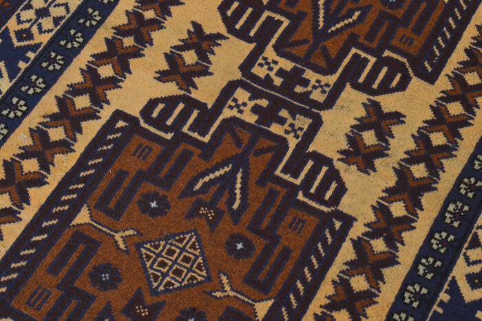 Geometric Afghan tribal rug with warm beige and navy tones, highlighted with rust accents. 4'8 x 2'9 ft, available in San Rafael and Berkeley showrooms