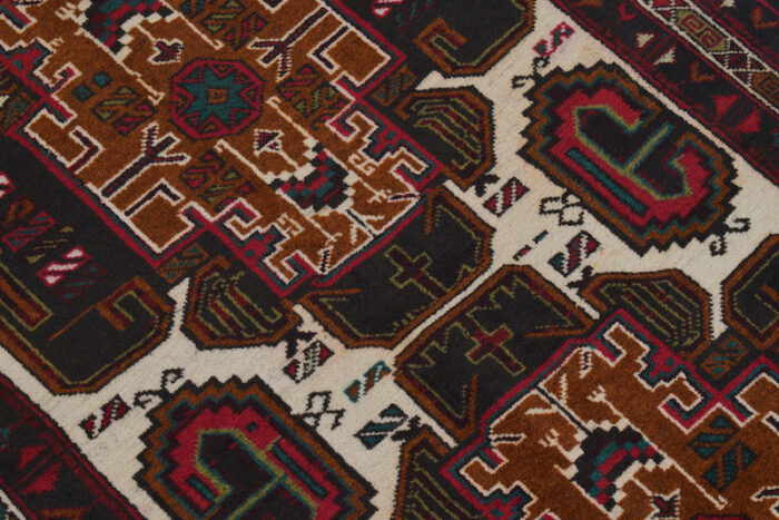 Traditional Afghan Baluch rug, 4'4 x 2'9 feet, featuring handcrafted tribal patterns. Washable and perfect for living rooms, bedrooms, and offices