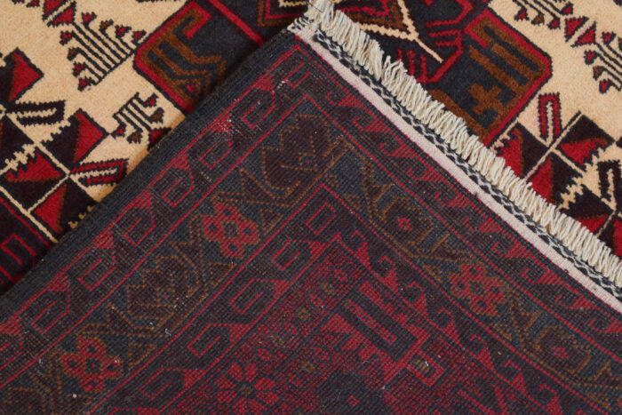 Authentic Afghan Baluchi tribal rug with a rich burgundy border and contrasting ivory center. Handmade and perfect for modern and traditional interiors."