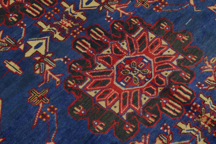 Geometric Afghan tribal rug with a rich color palette of navy, red, and beige. A perfect addition to living rooms, bedrooms, and office spaces.