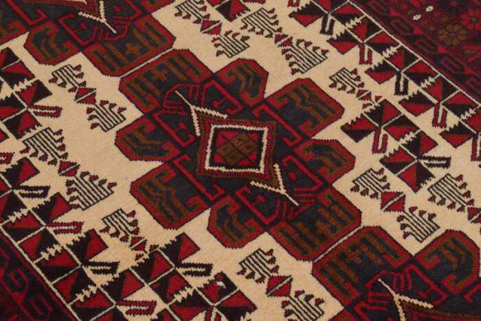 Vintage Afghan Baluch rug 6'7 x 4'3 ft featuring geometric motifs in deep red, maroon, and black. High-quality wool, washable, and stain-resistant.