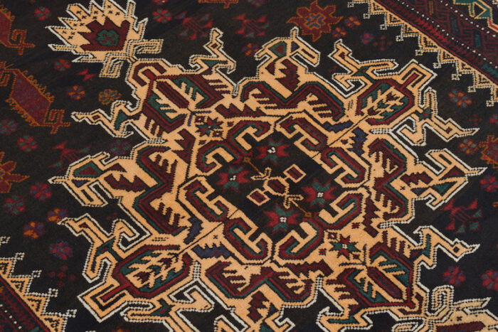 Handwoven Afghan Baluch rug 6'3 x 4'2 ft in deep brown and black with golden tribal medallion motifs. Available in San Francisco, Berkeley, and Moraga, CA."