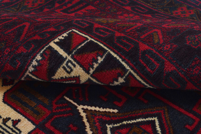 Geometric Afghan tribal rug with bold medallion patterns in ivory, burgundy, and dark brown. A perfect addition to living rooms, bedrooms, or offices."