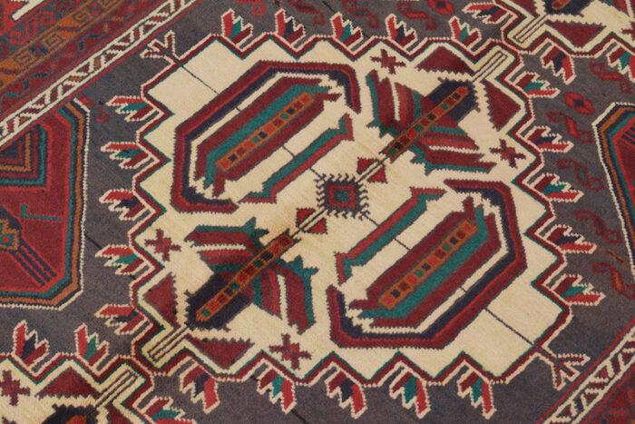 Vintage Baluchi rug 6'8 x 4'1 ft, featuring a cream background with deep red, dark gray, and teal tribal motifs."