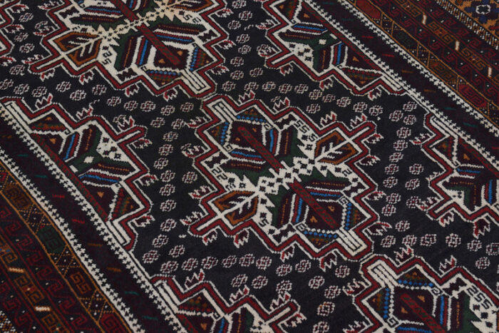 Vintage Afghan tribal rug featuring intricate symmetrical patterns and soft wool for long-lasting use.