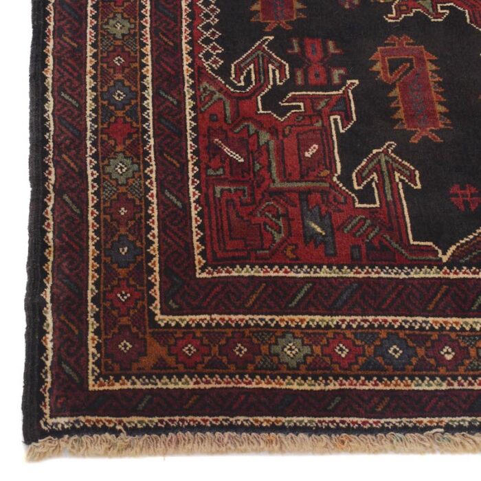 Traditional Afghan tribal rug with deep black and red medallions, perfect for living rooms and home offices