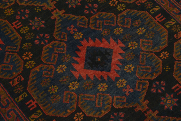 Handwoven Afghan Baluchi rug 5'8 x 3'2 ft with deep black base, rust medallions, and intricate tribal patterns.