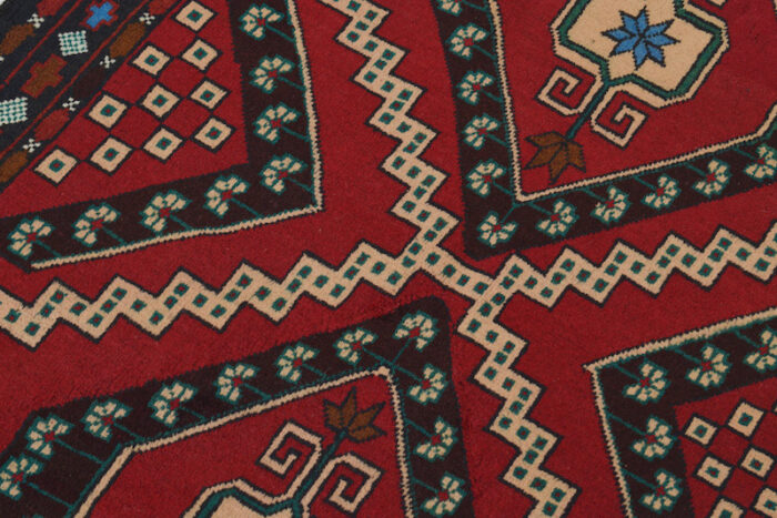 Traditional Afghan wool rug with diamond medallion designs in red, black, and ivory. 4'6 x 2'10 ft, perfect for living rooms, offices, and hallways.